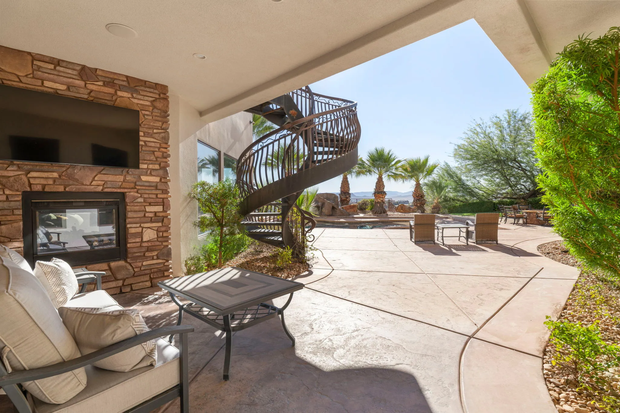 View of patio / terrace with an outdoor stone fireplace and stairway