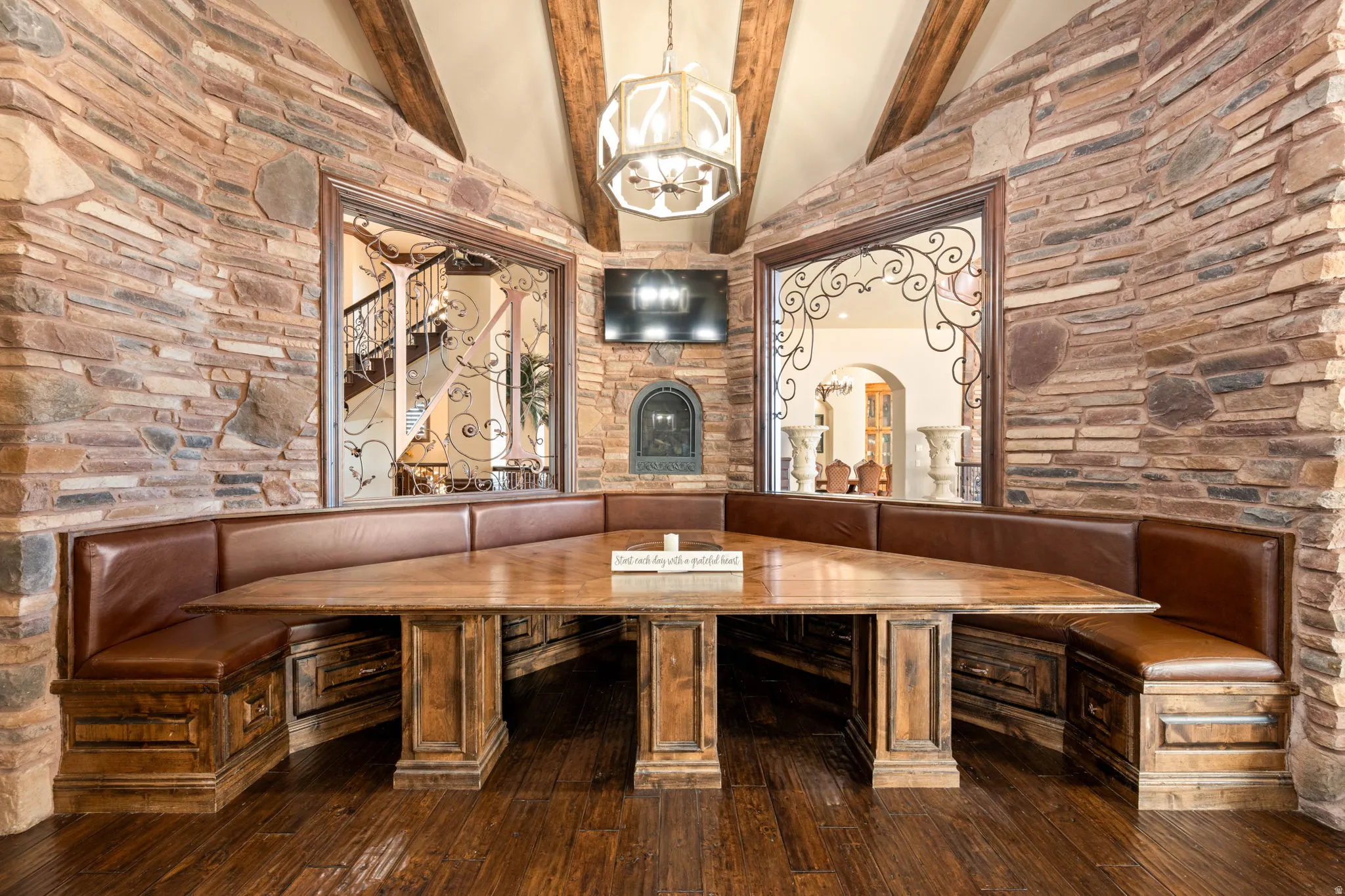 Wine room with hardwood / wood-style flooring, beamed ceiling, high vaulted ceiling, and a chandelier