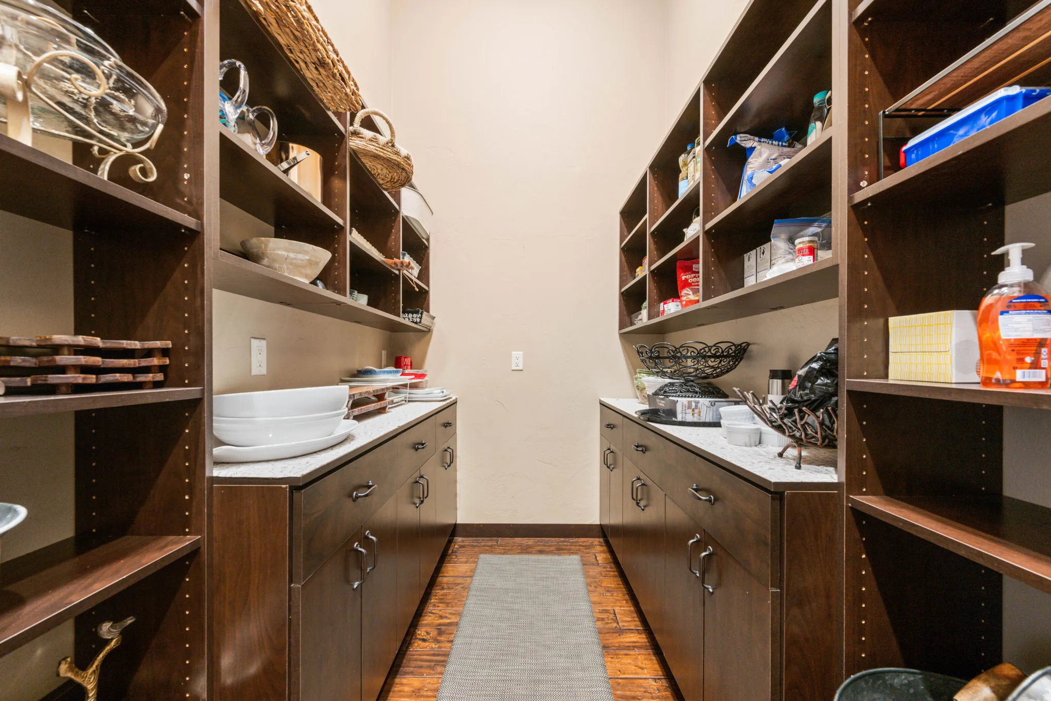 Laundry room with dark wood-type flooring and baseboards