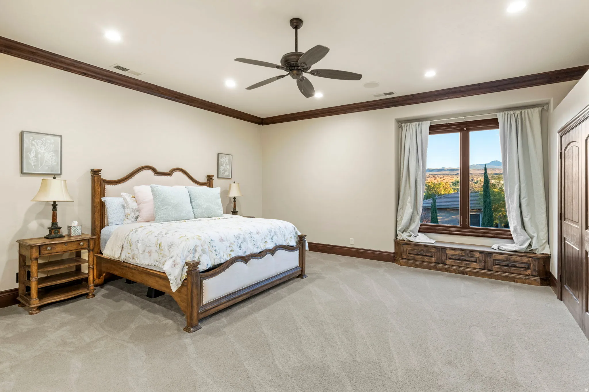 Bedroom with light colored carpet, crown molding, a ceiling fan, and recessed lighting