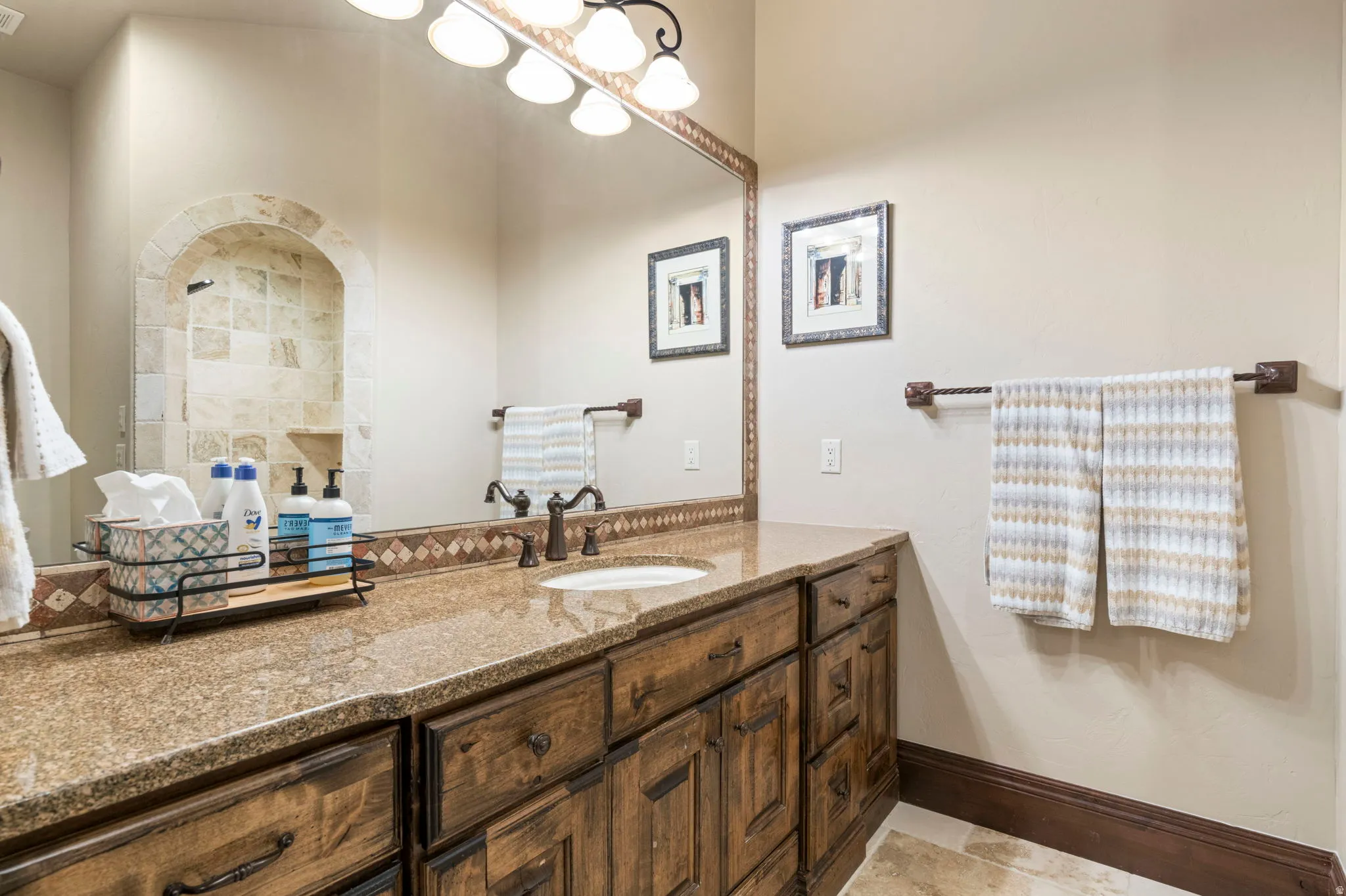 Bathroom with vanity and tiled shower