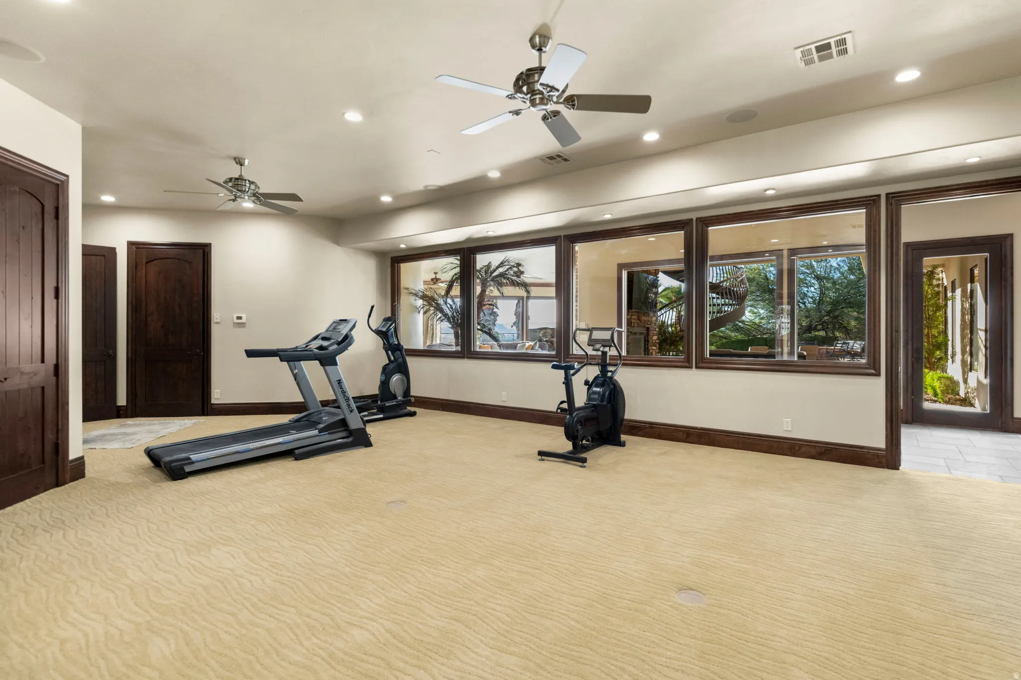 Exercise room with recessed lighting and a ceiling fan