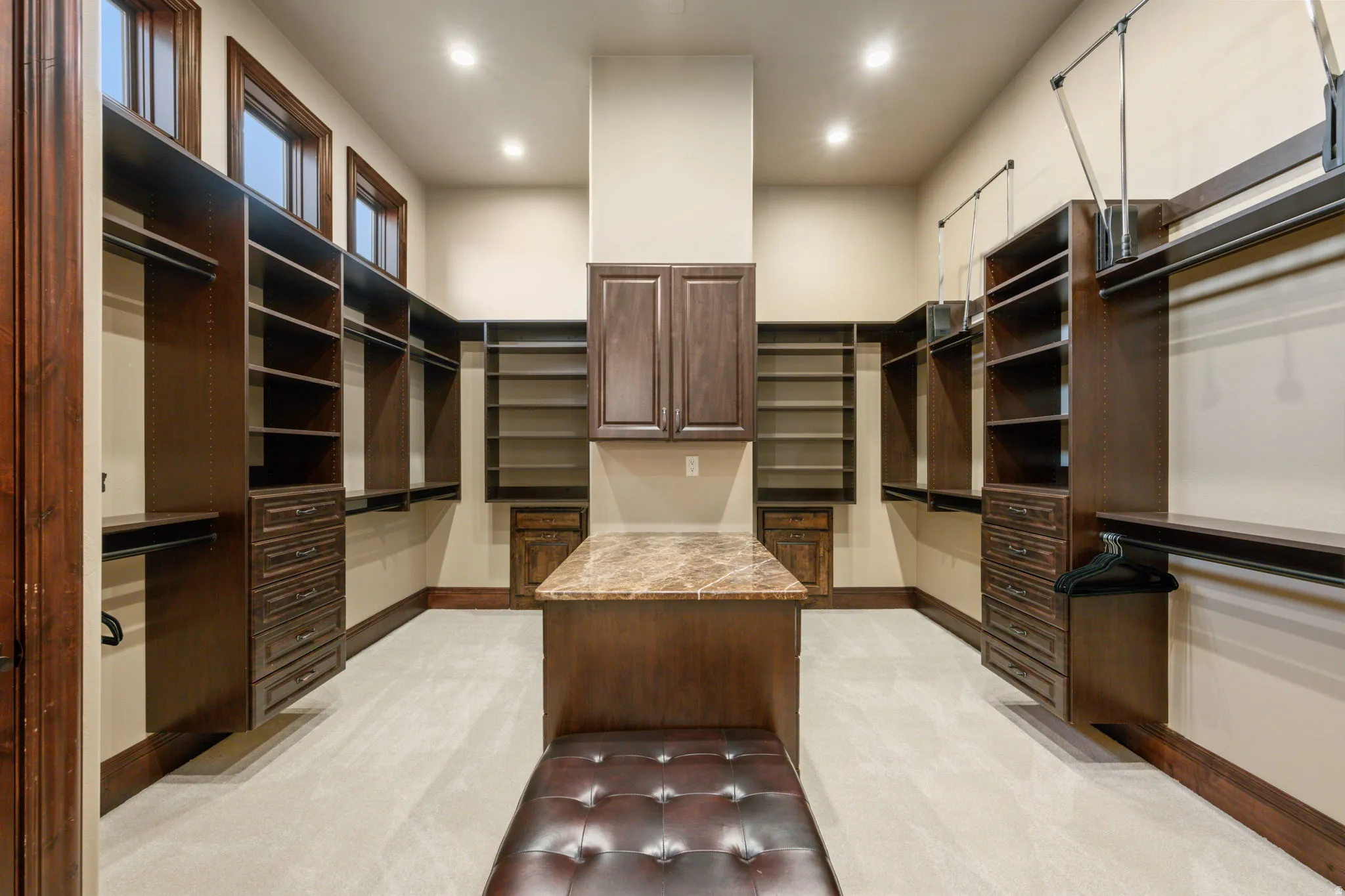 Walk in closet featuring light colored carpet