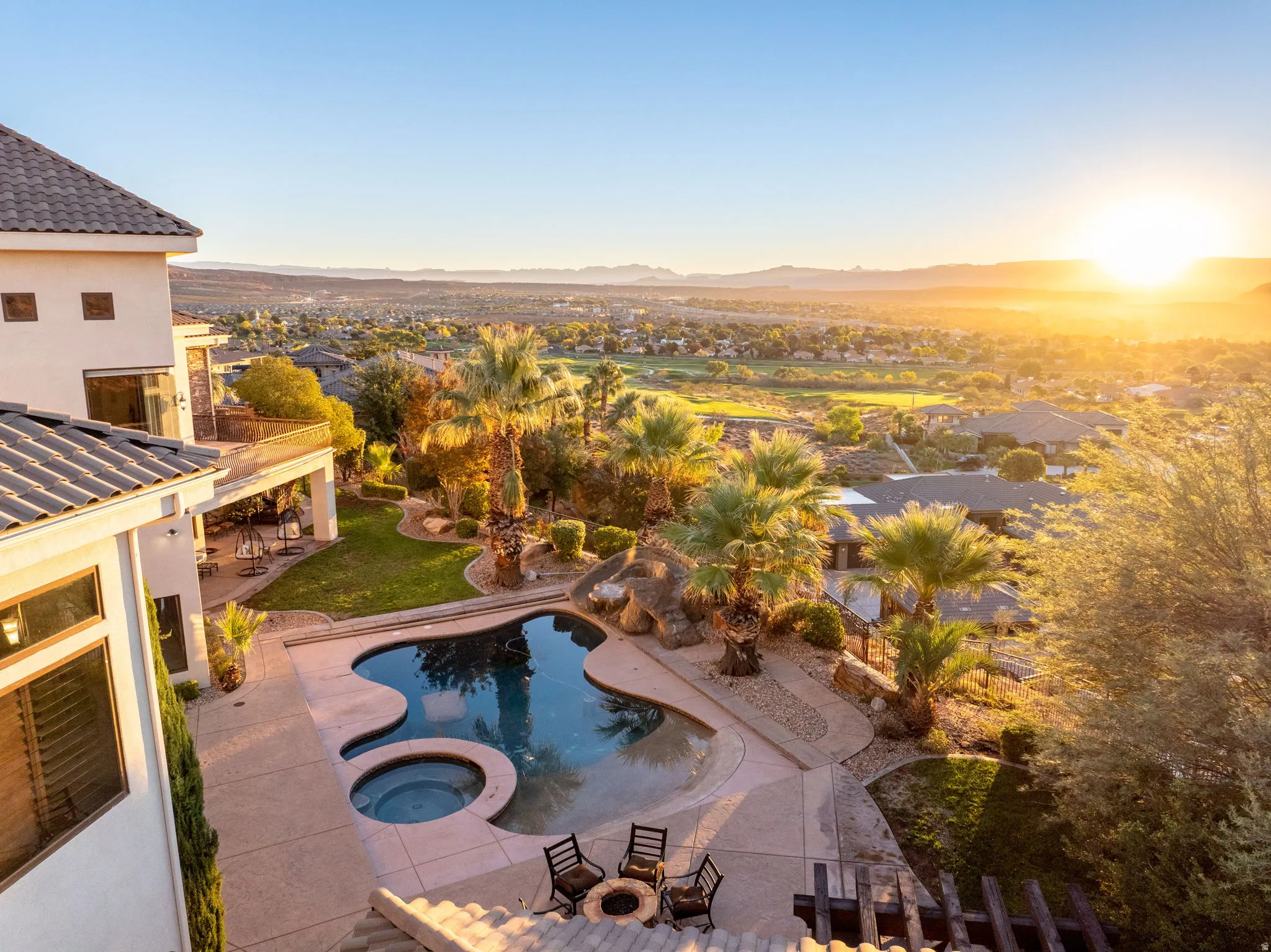 View of pool with a patio, a pool with connected hot tub, and a mountain view