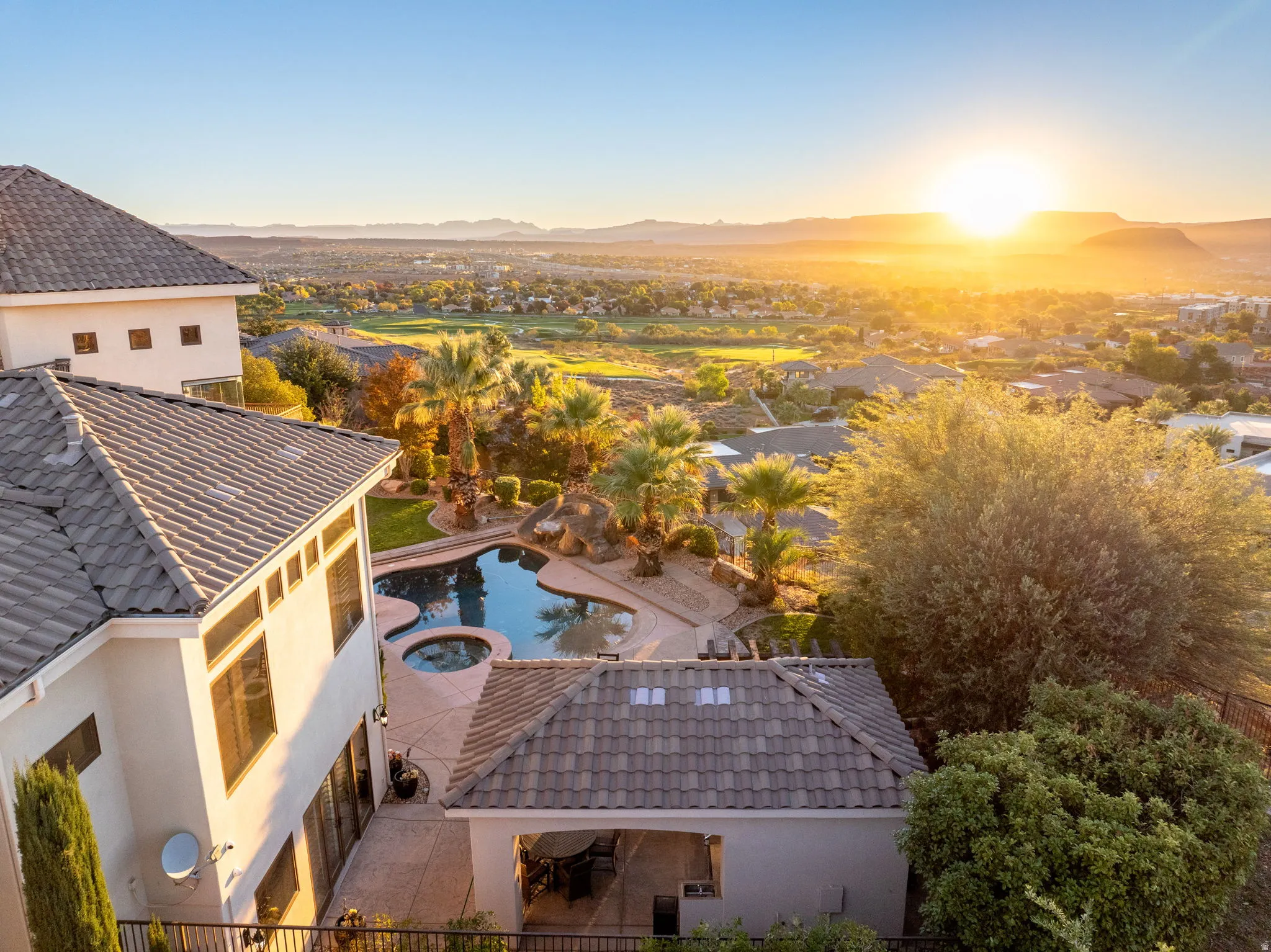 Aerial view of a pool and a mountainous background