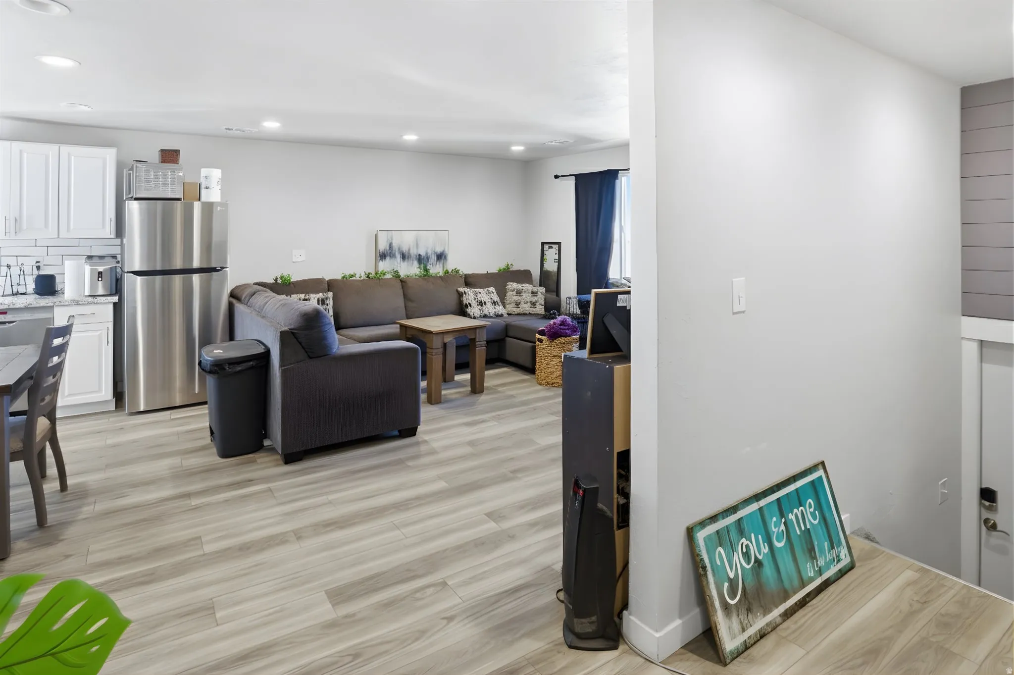 Living room featuring recessed lighting and light wood-style flooring