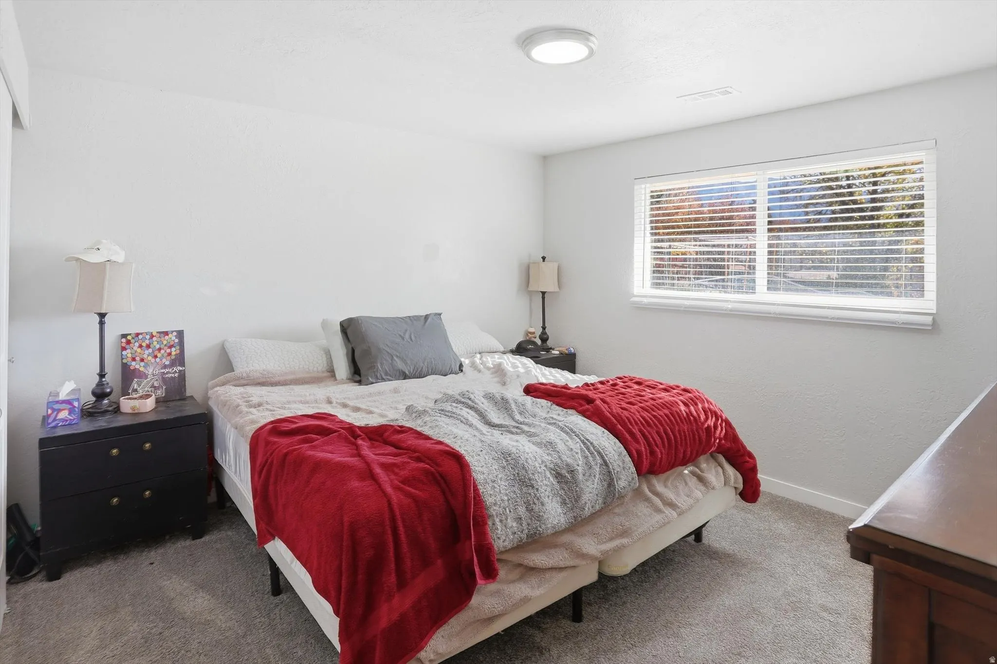 Bedroom featuring carpet floors and baseboards