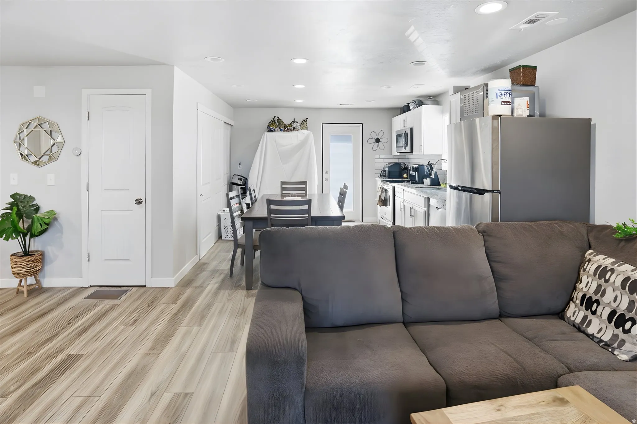 Living area featuring recessed lighting and light wood-style floors