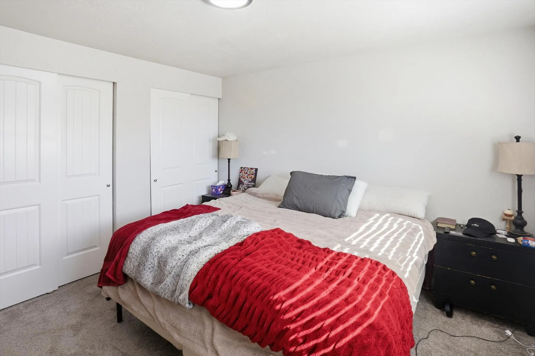 Bedroom featuring carpet and multiple closets