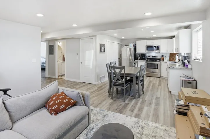 Living area with light wood-type flooring and recessed lighting
