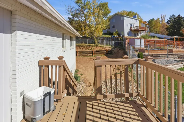Wooden deck featuring a garden and a fenced backyard