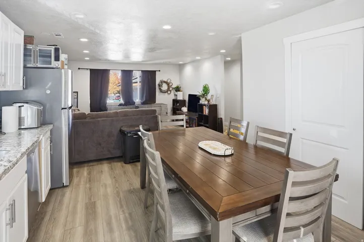 Dining room featuring light wood finished floors, recessed lighting, and a textured ceiling
