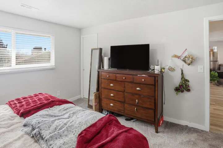 Bedroom featuring light colored carpet