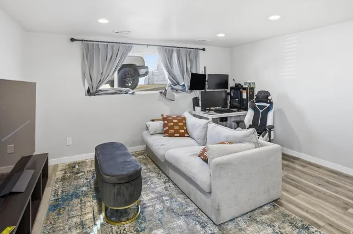 Living room featuring recessed lighting, wood finished floors, and a desk