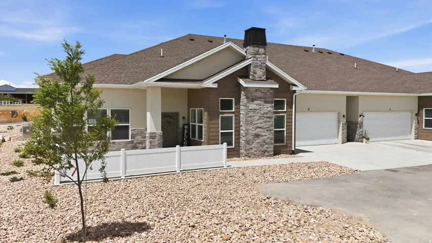Exterior featuring a stone chimney, horizontal siding, and a gabled roofline