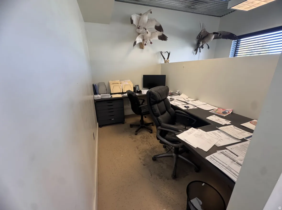 Office area featuring finished concrete flooring