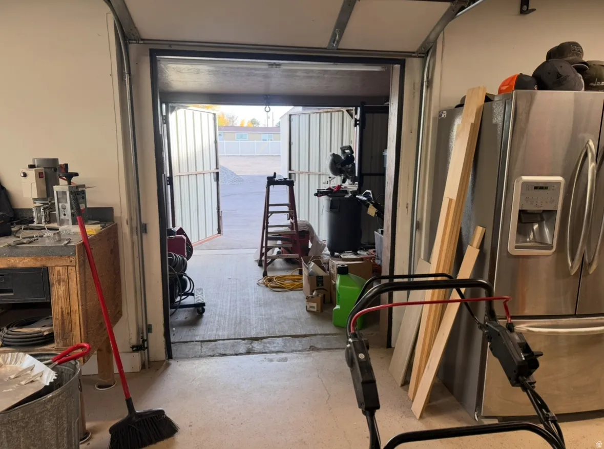 Garage featuring stainless steel fridge