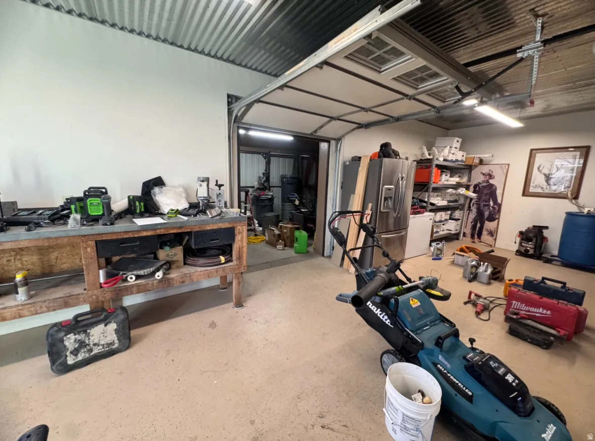 Garage featuring stainless steel refrigerator with ice dispenser