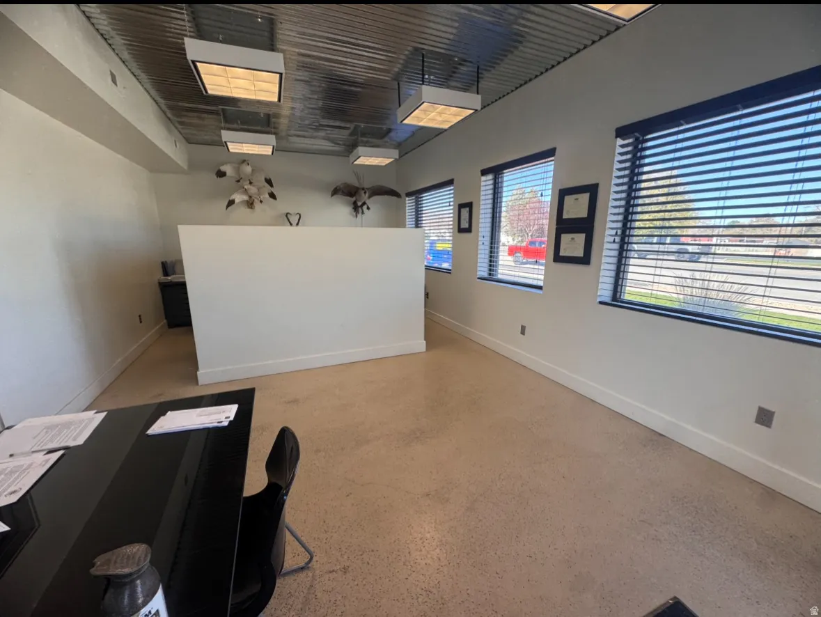 Office with baseboards and dark speckled floor