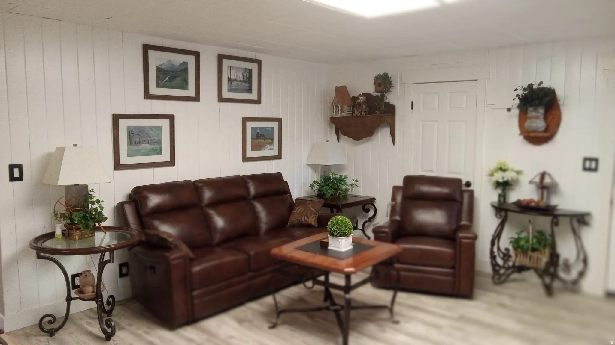 Living area with wood finished floors and wooden walls