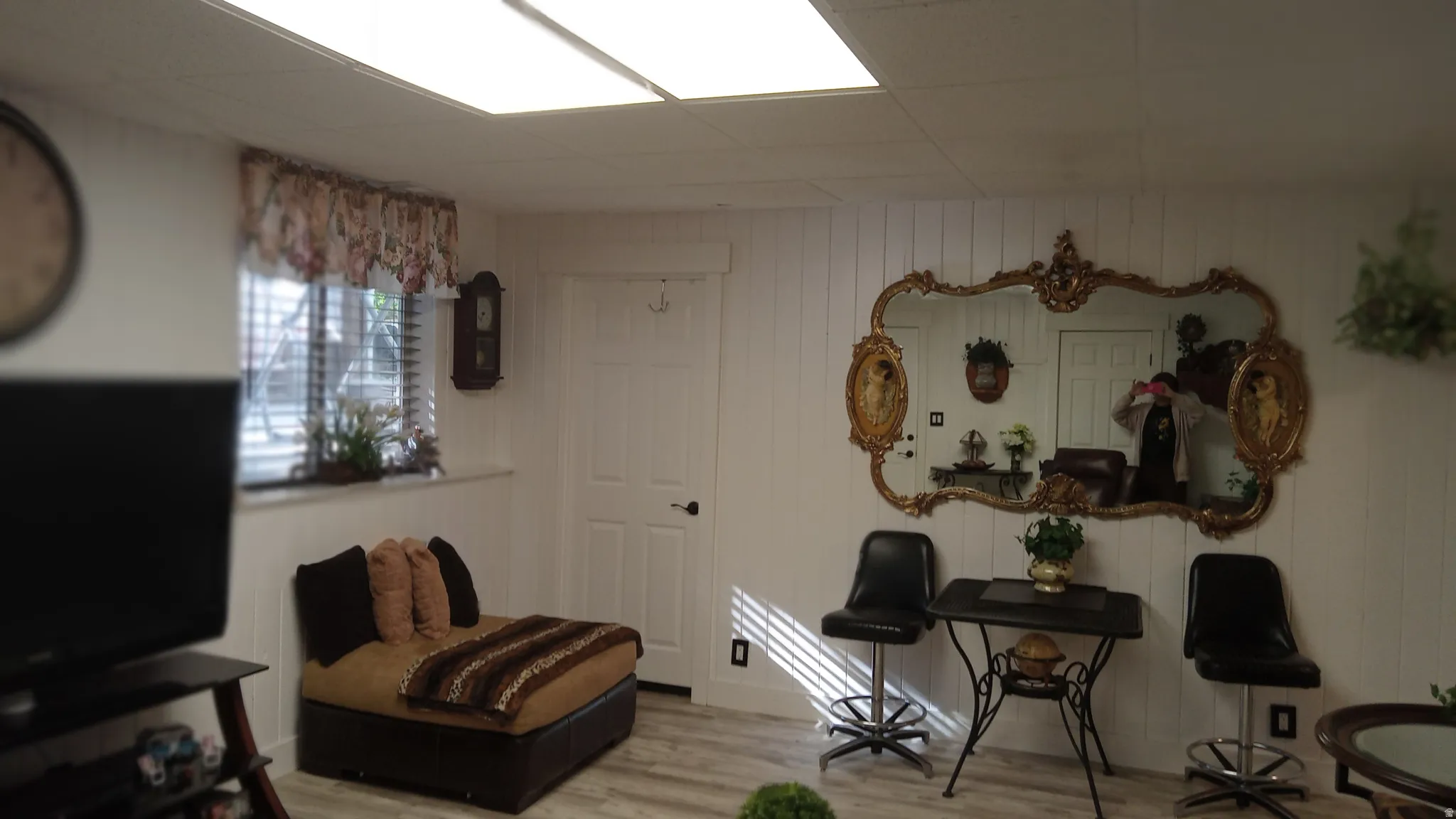 Living area featuring wood finished floors and wooden walls
