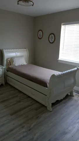 Bedroom with dark wood-style floors
