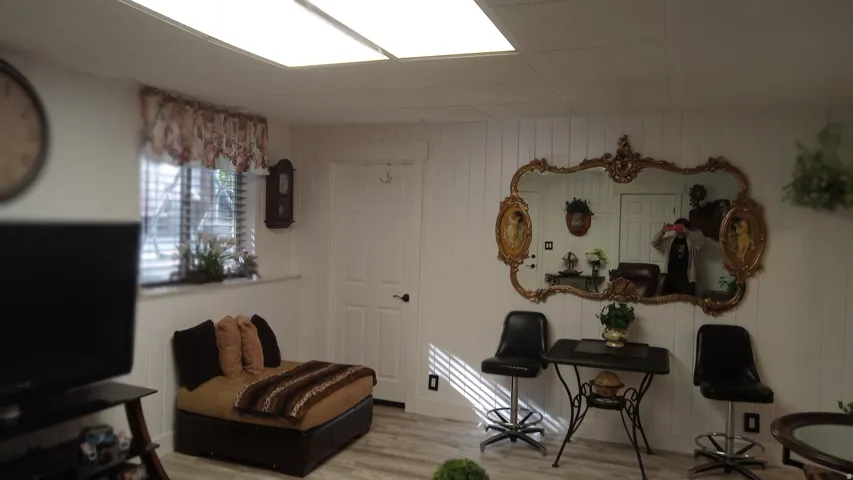 Living area featuring wood finished floors and wooden walls