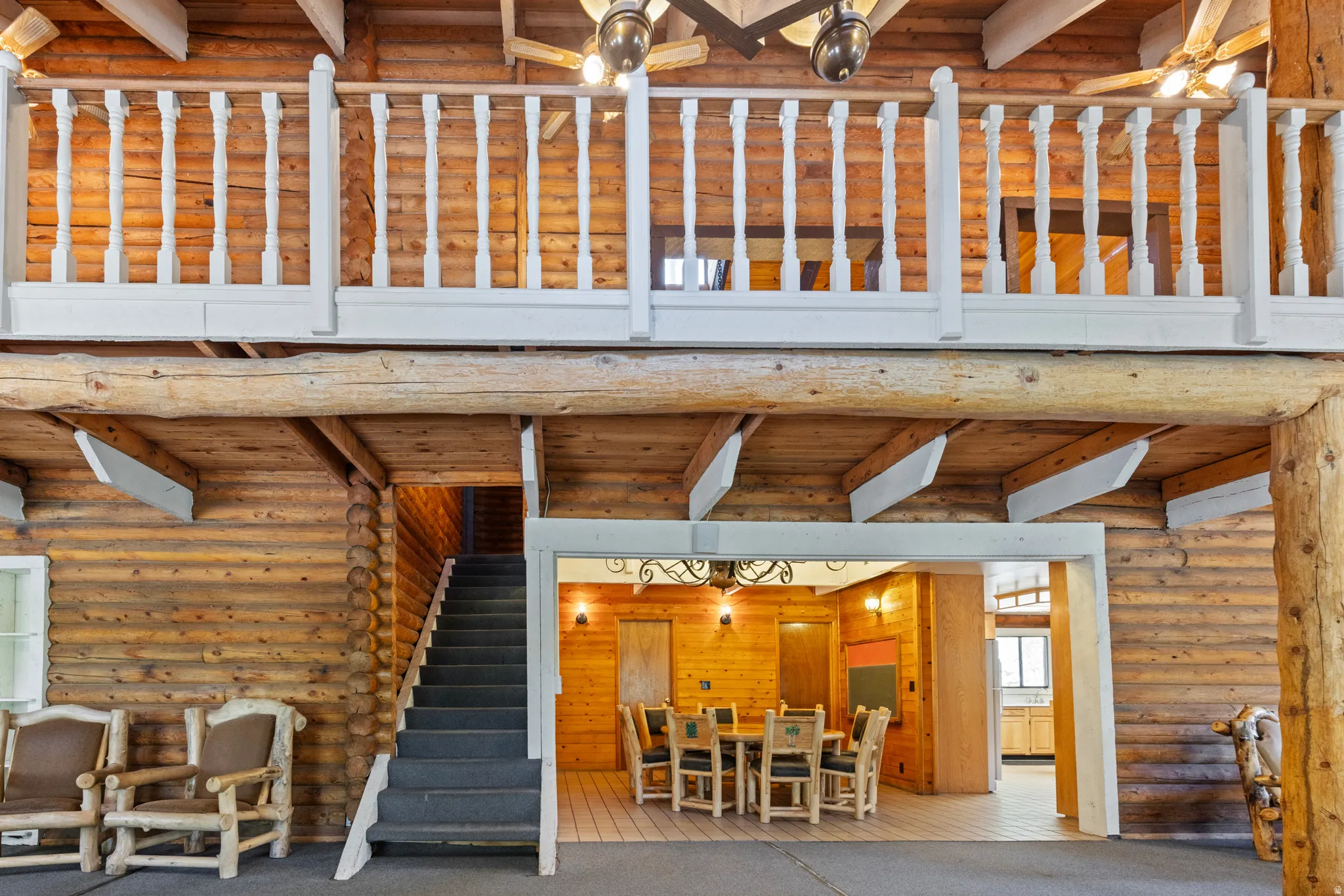 View of patio / terrace featuring a wooden deck, stairway, and outdoor dining space