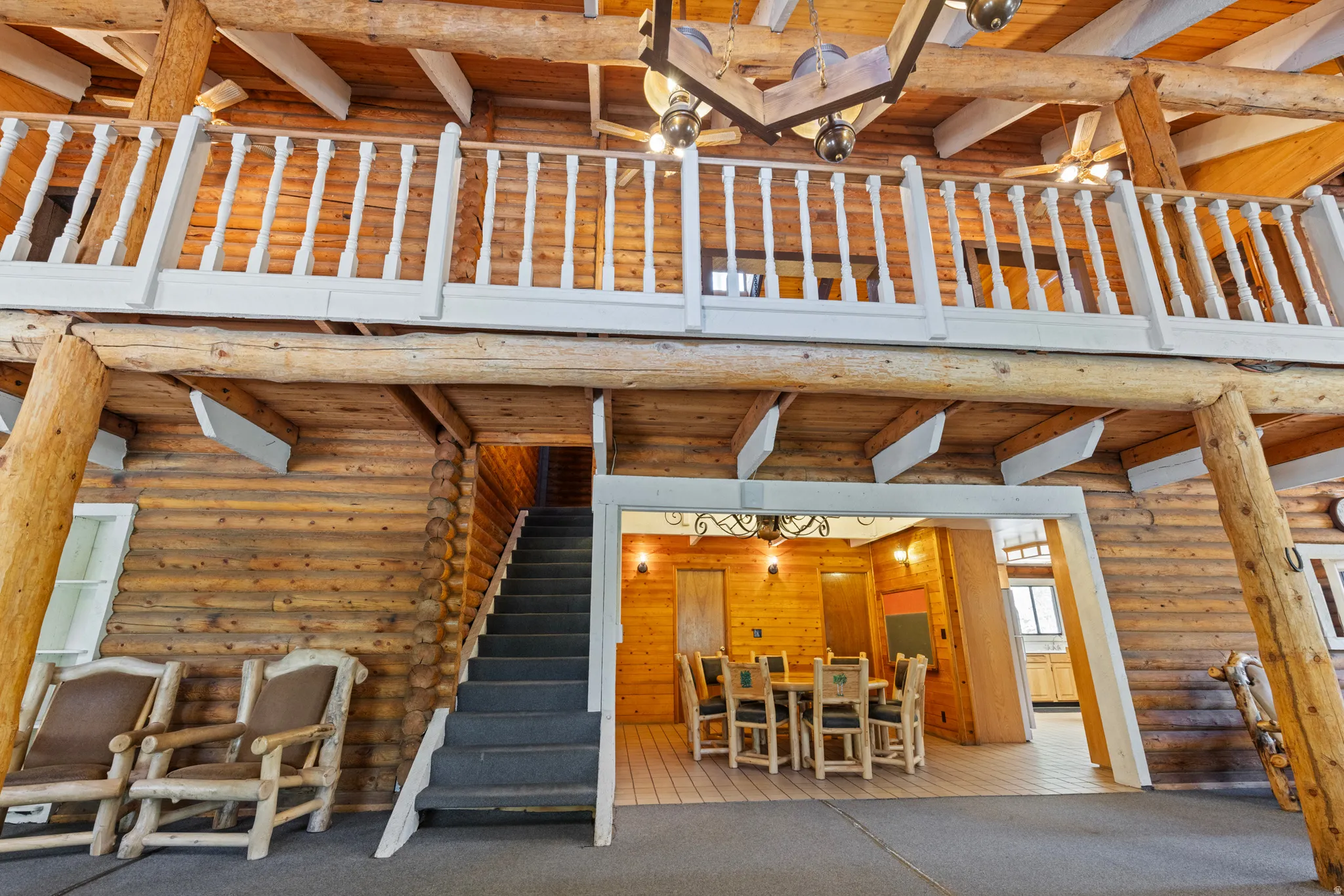 View of patio / terrace with a wooden deck, stairway, and outdoor dining area