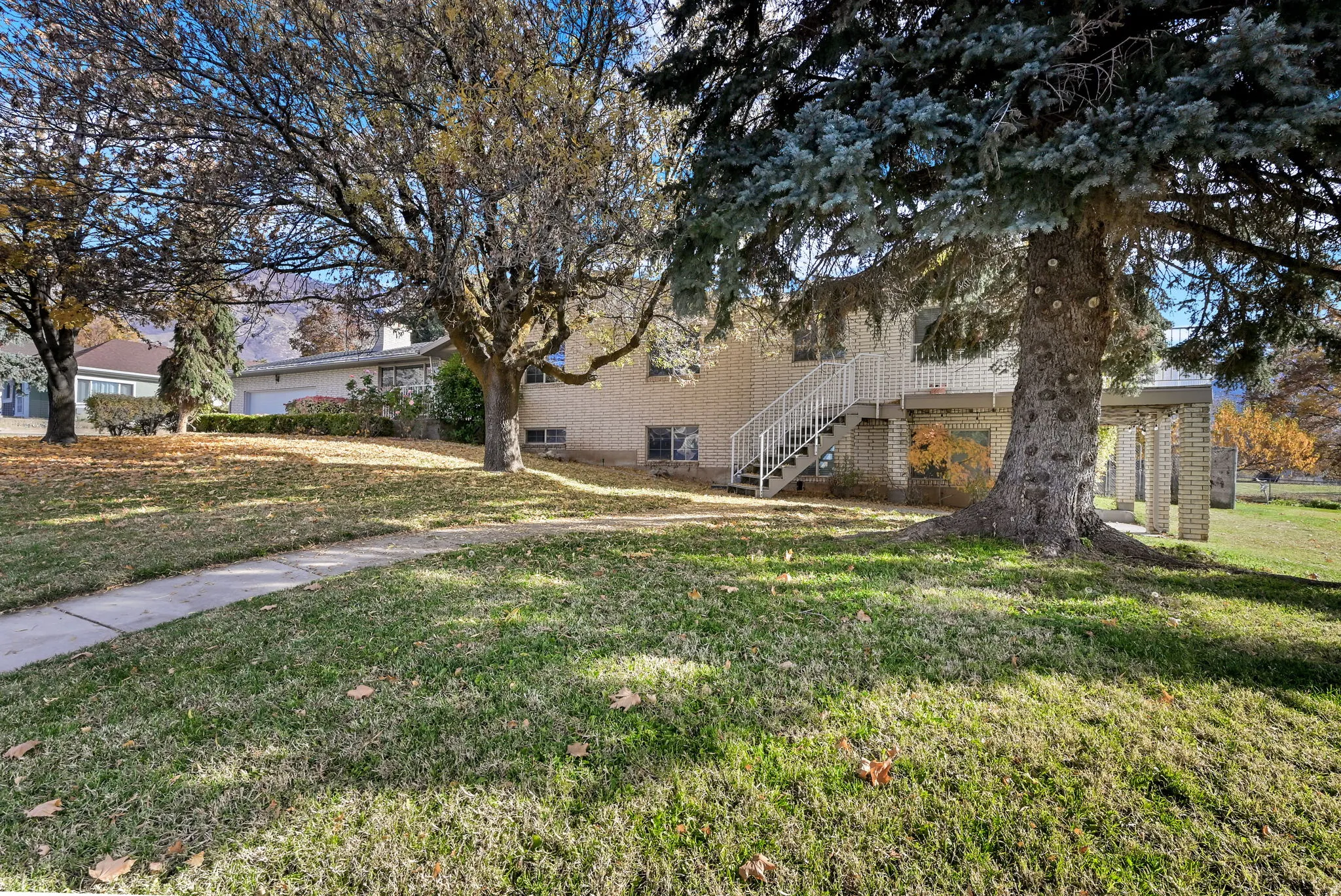 View of green lawn featuring stairs