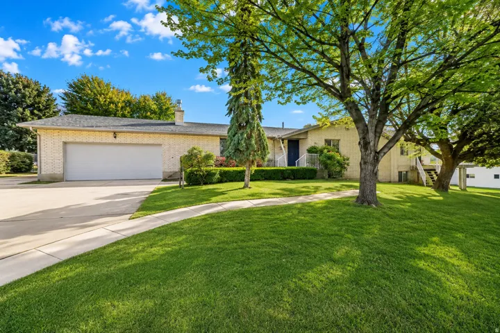 Brick exterior with an attached garage and concrete driveway