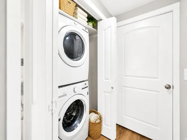 Stackable washer and dryer appliances within a dedicated closet