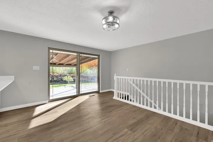 Unfurnished room with wood finished floors and a textured ceiling