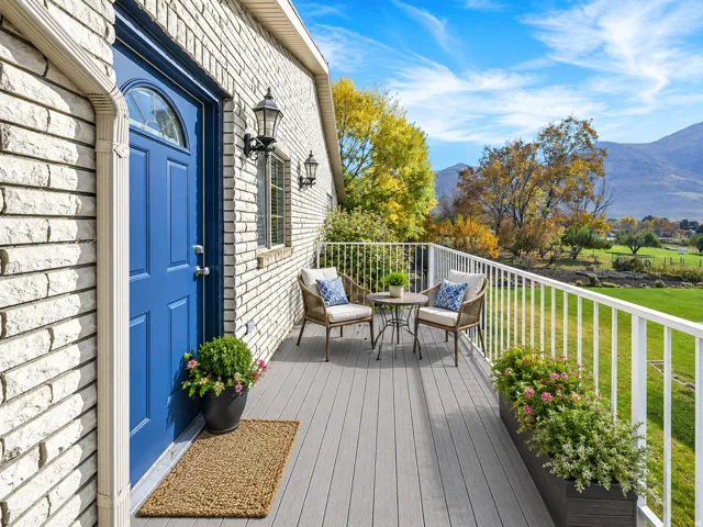 White brick exterior with a vibrant blue entry door and transom window