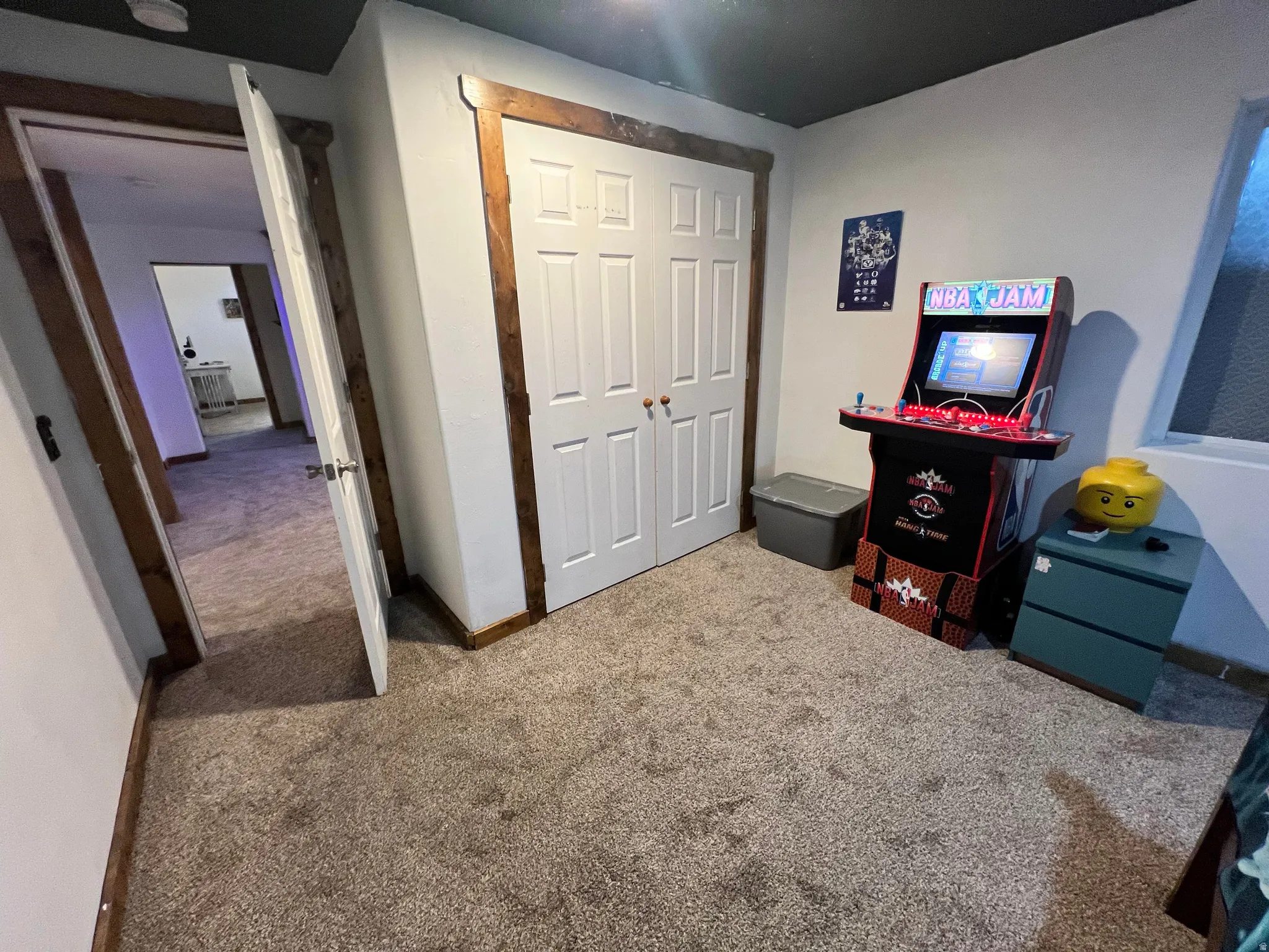 Carpeted bedroom featuring a closet and baseboards