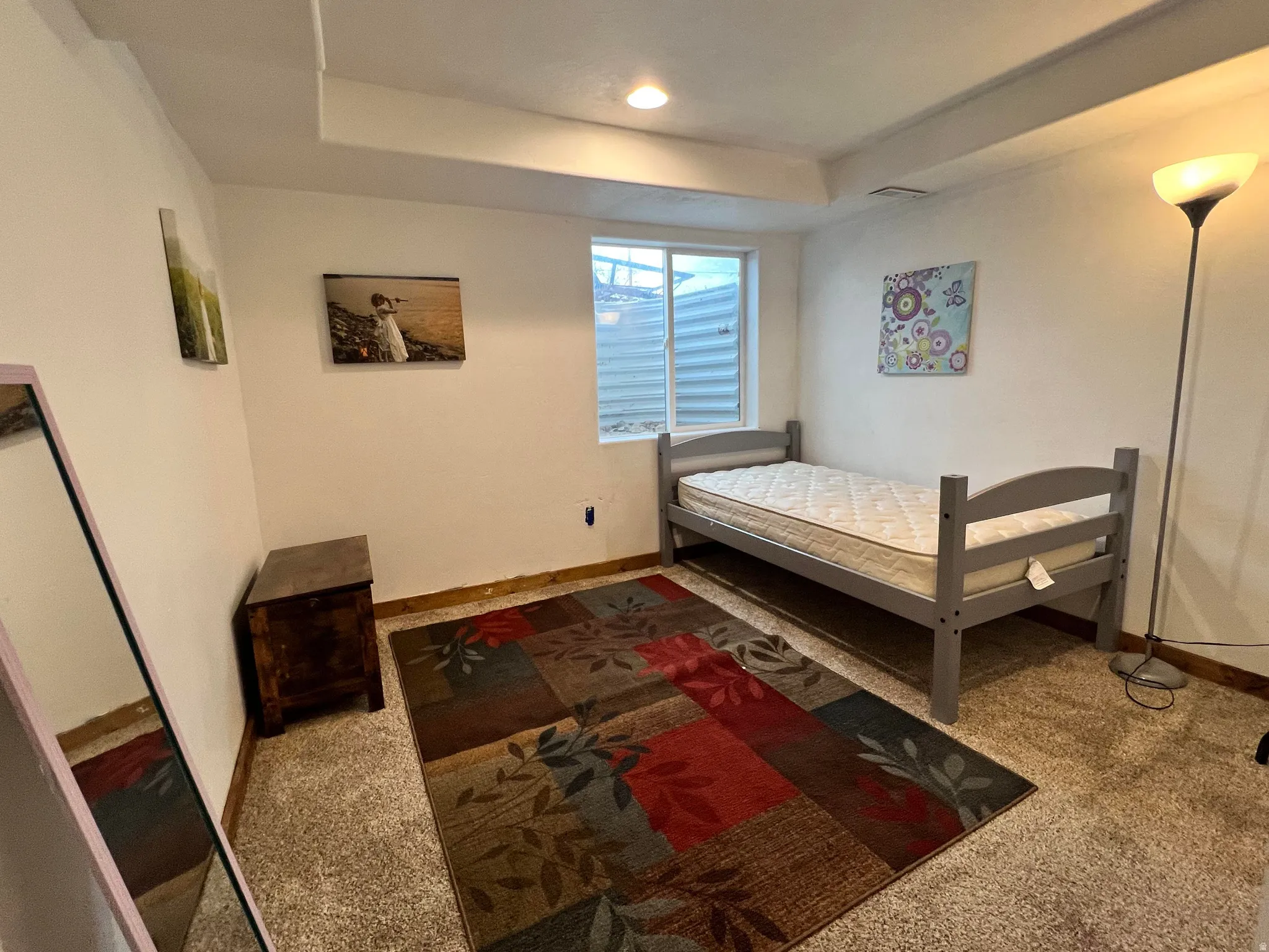 Bedroom featuring carpet floors and a tray ceiling
