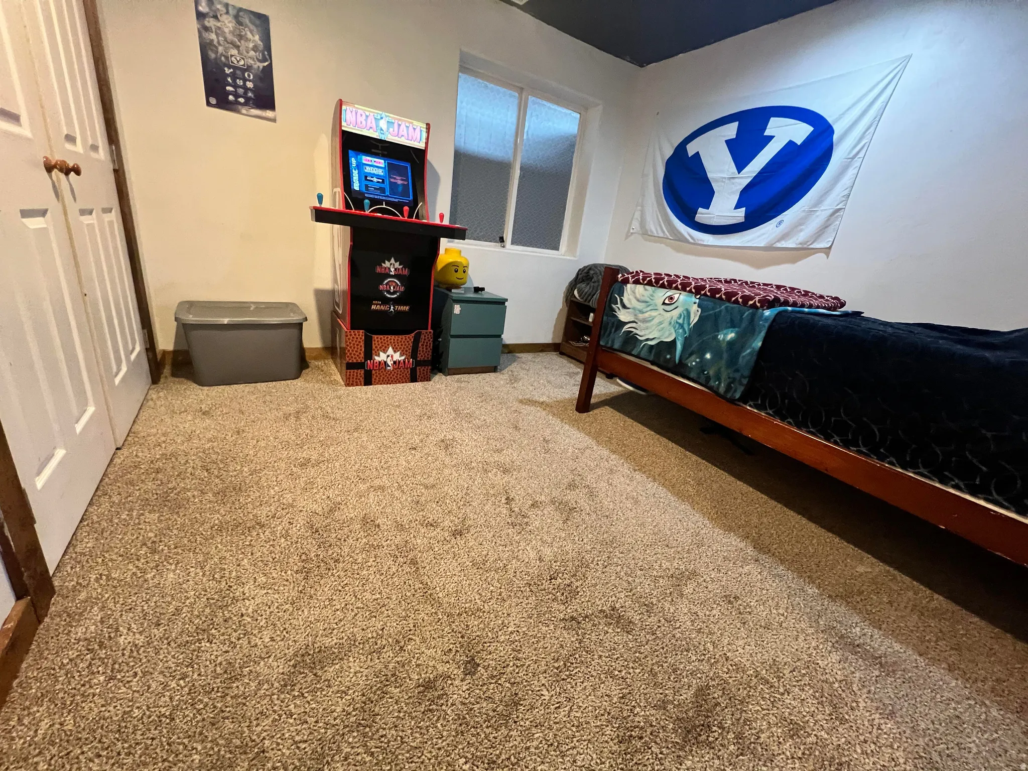 Carpeted bedroom featuring a closet and baseboards