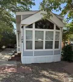 View of side of property with a sunroom