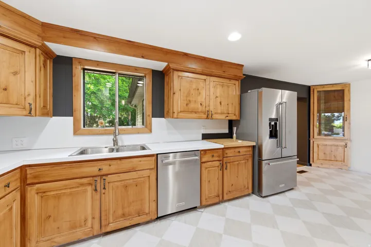 Kitchen featuring light floors, light countertops, stainless steel appliances, and recessed lighting