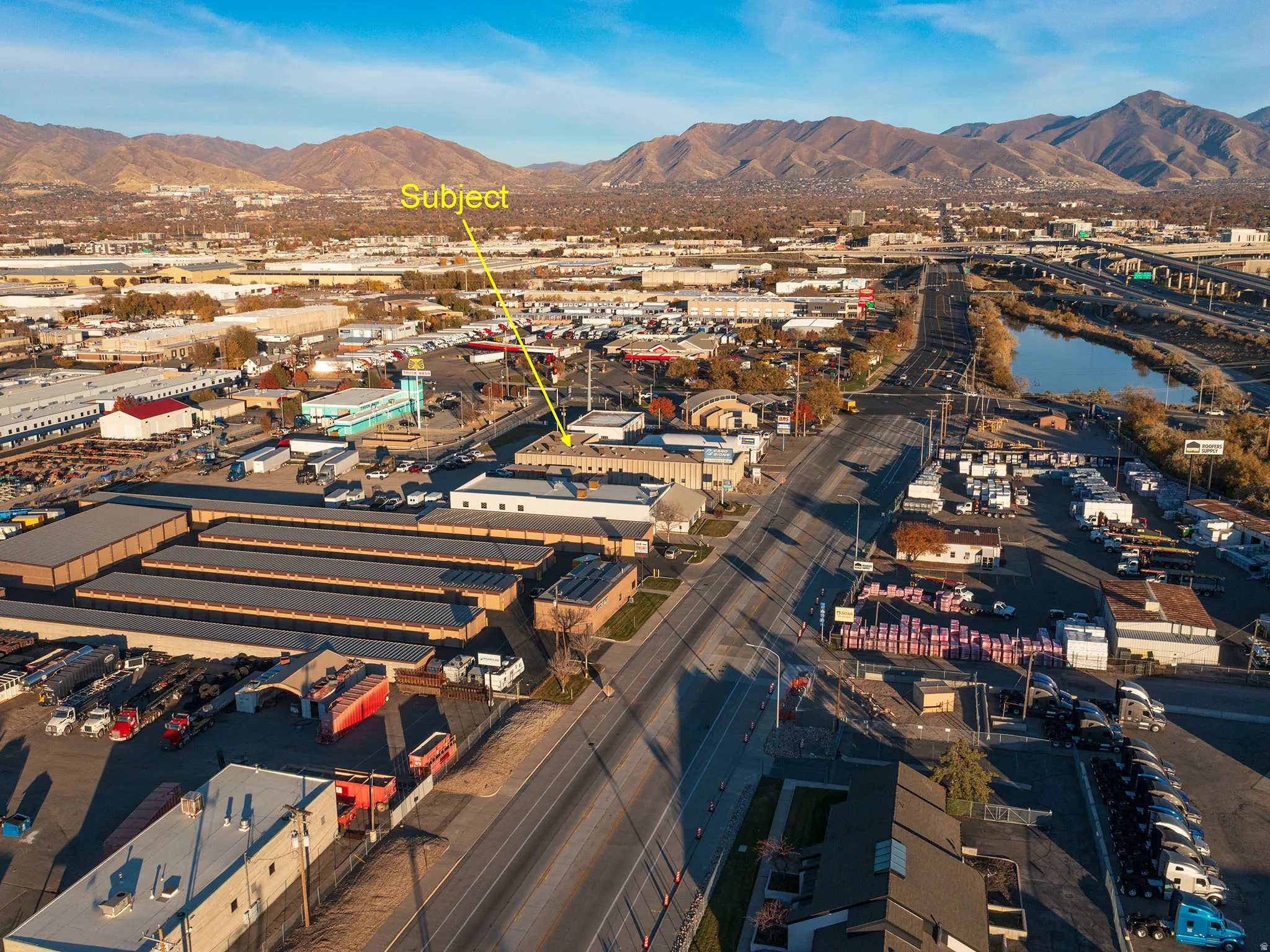 Drone / aerial view of an industrial area and a mountain backdrop