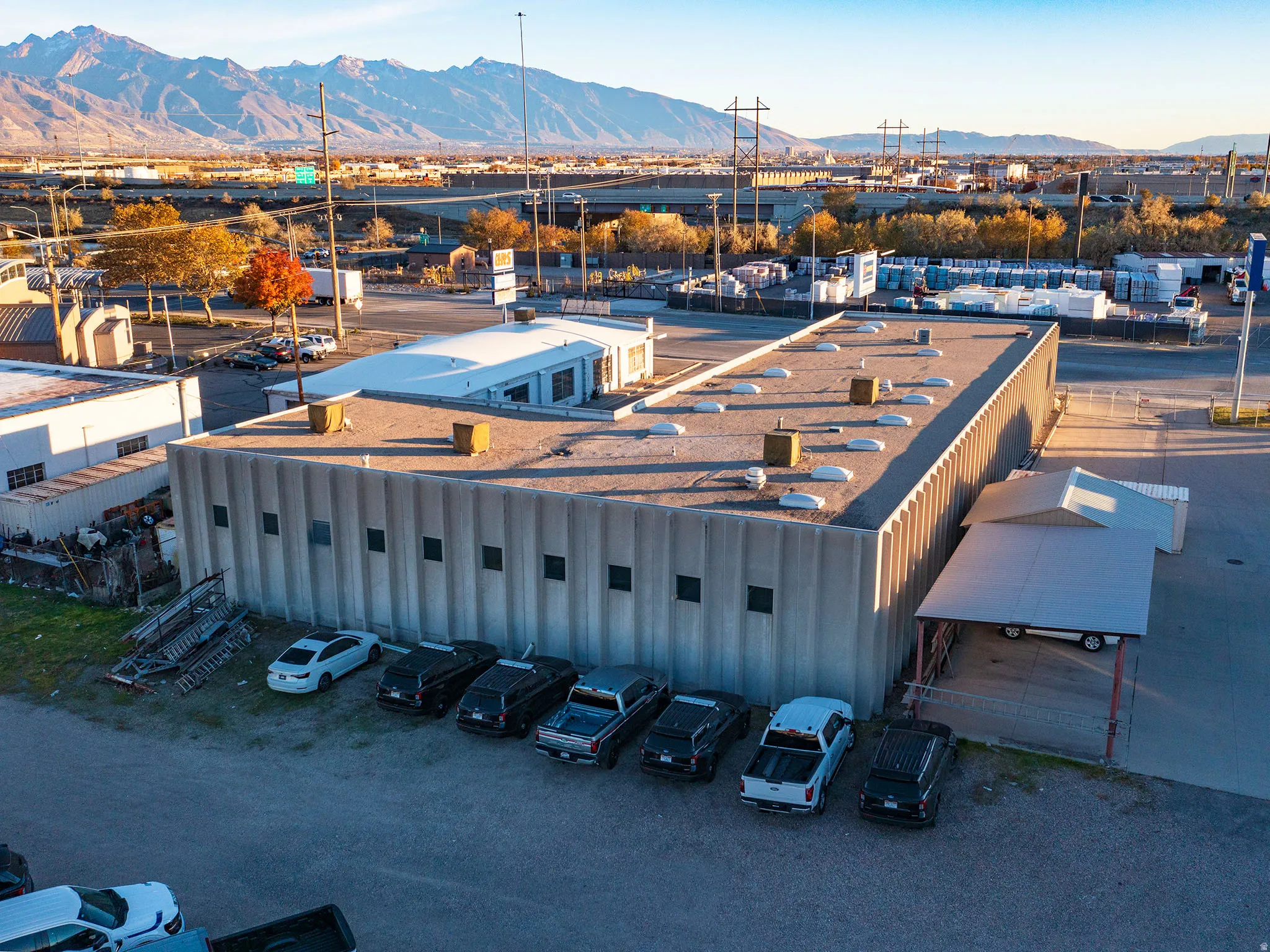 Aerial view of industrial structures and a mountain backdrop