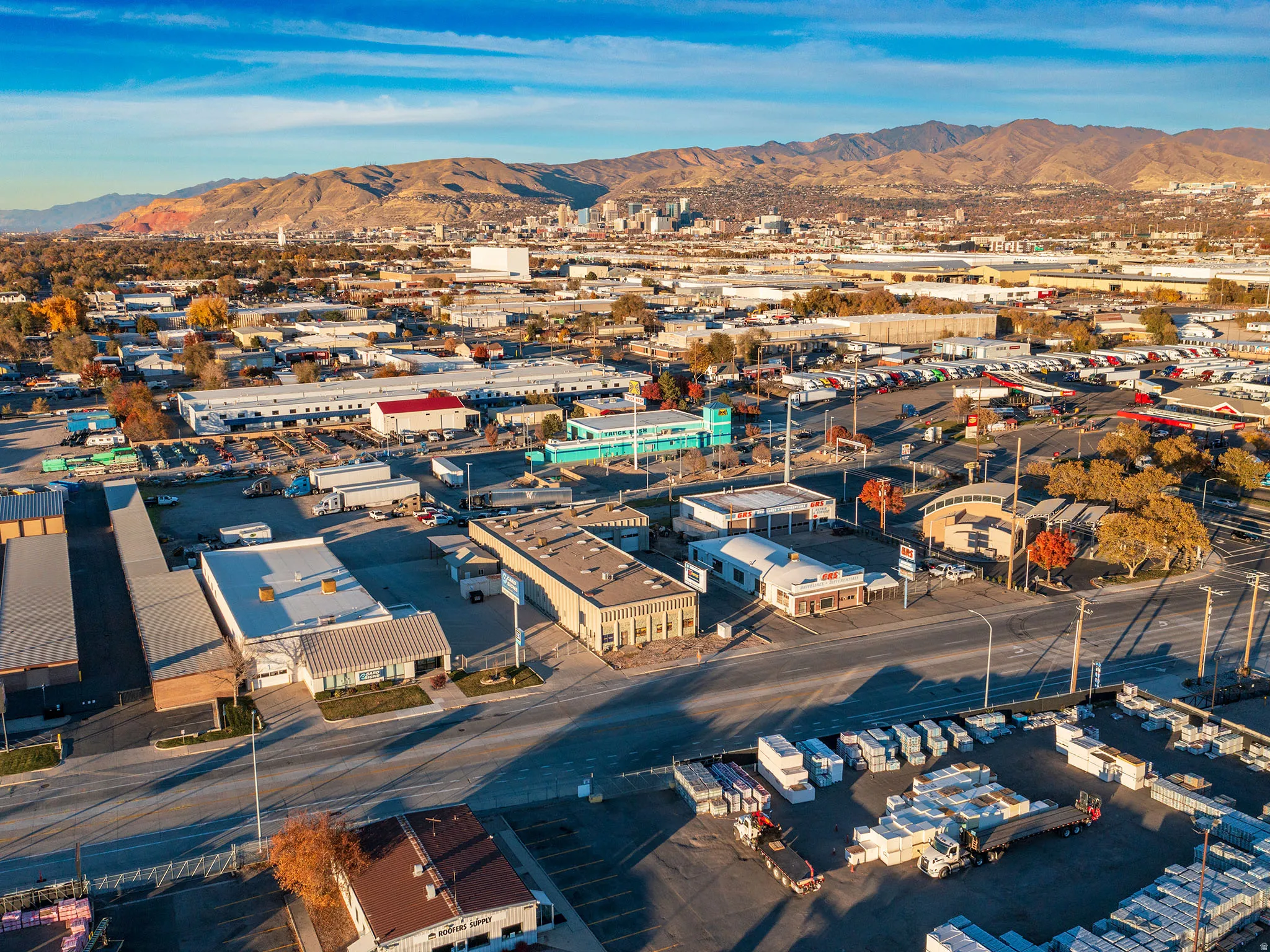 Bird's eye view of industrial structures and a mountain backdrop