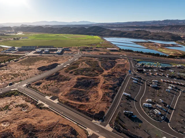 Aerial view of property and surrounding area with a water and mountain view