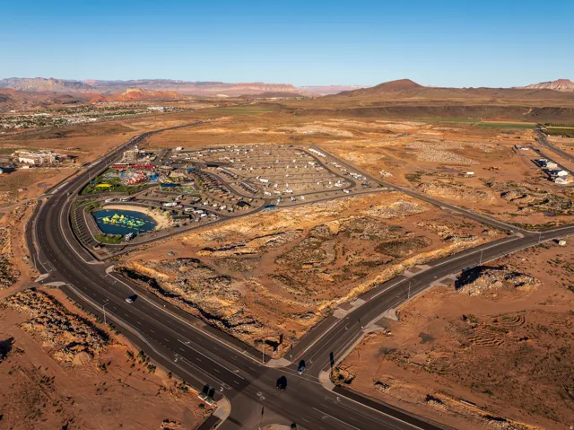 Aerial view of property and surrounding area featuring mountains and rural landscape