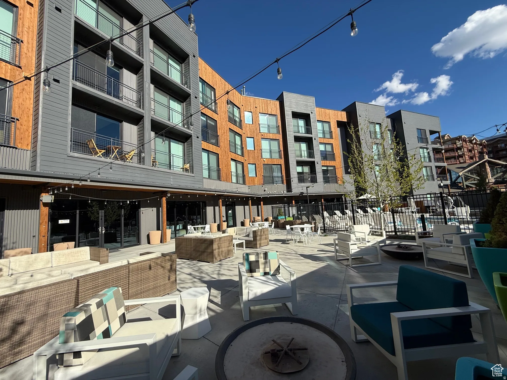 View of home's community featuring an outdoor living space with a fire pit and a patio