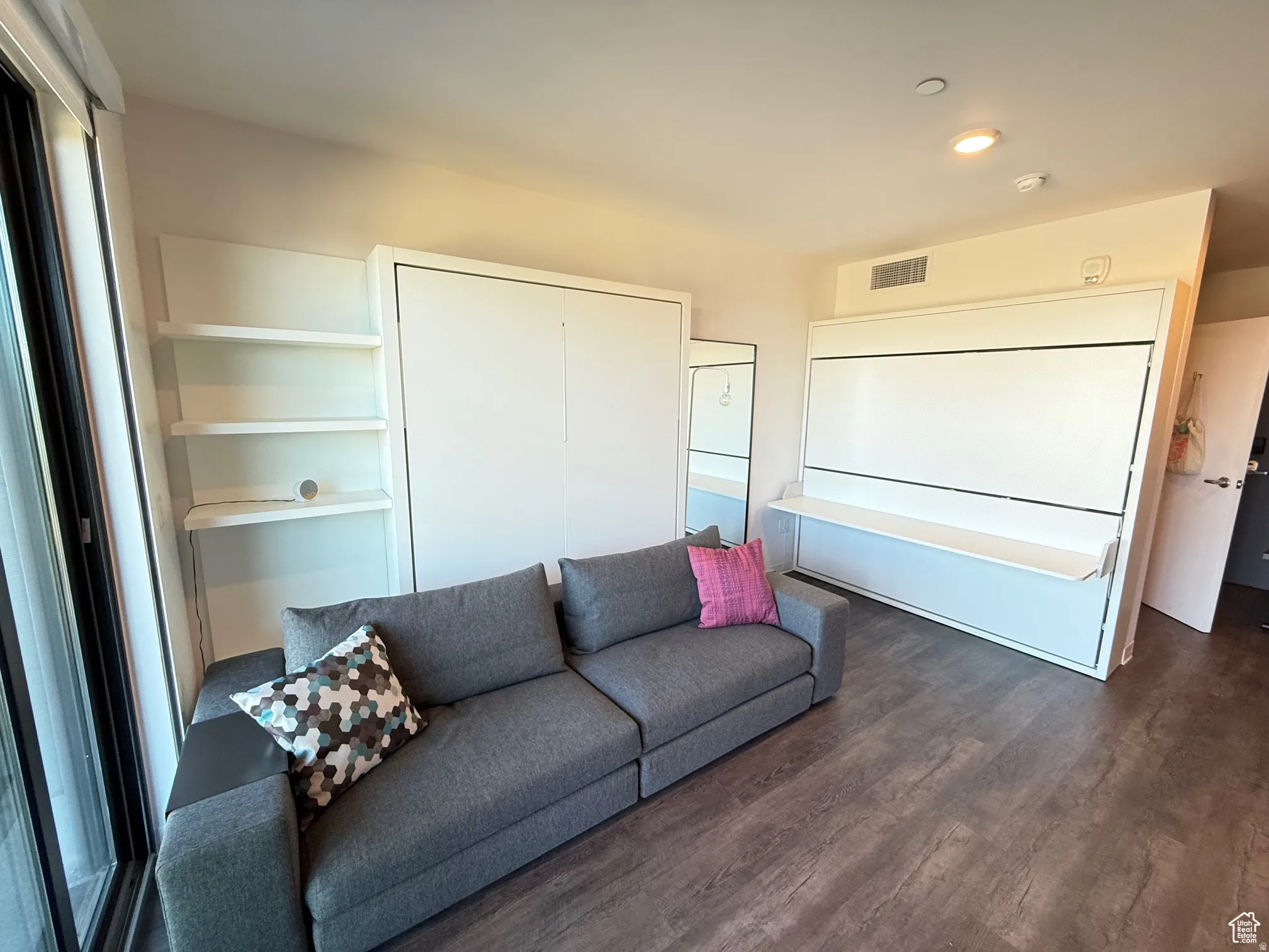 Living area featuring wood finished floors and recessed lighting