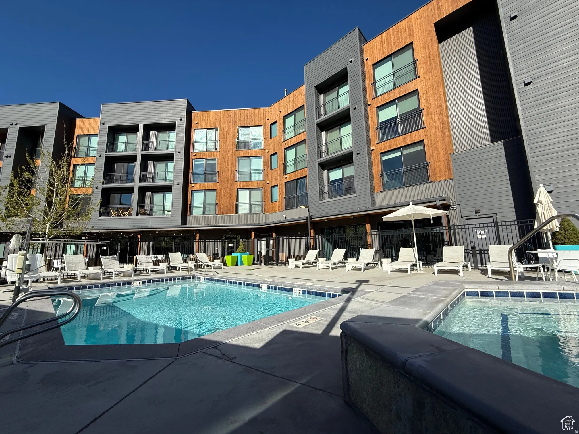 Community pool with a patio