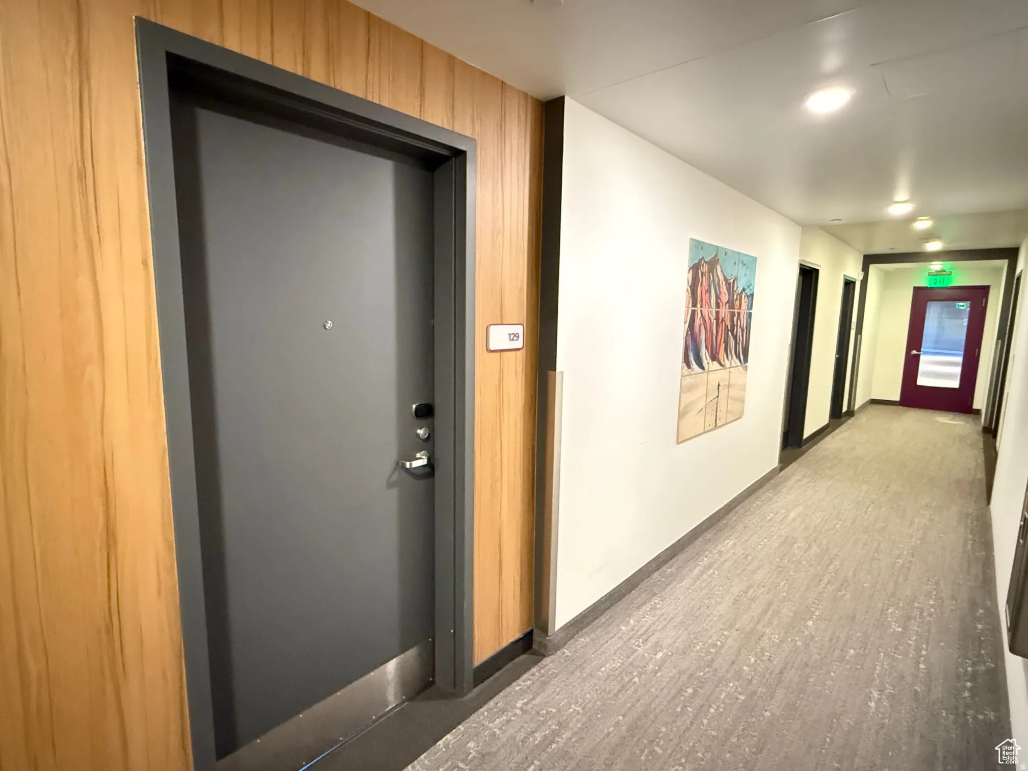 Hallway featuring wood finished floors and baseboards