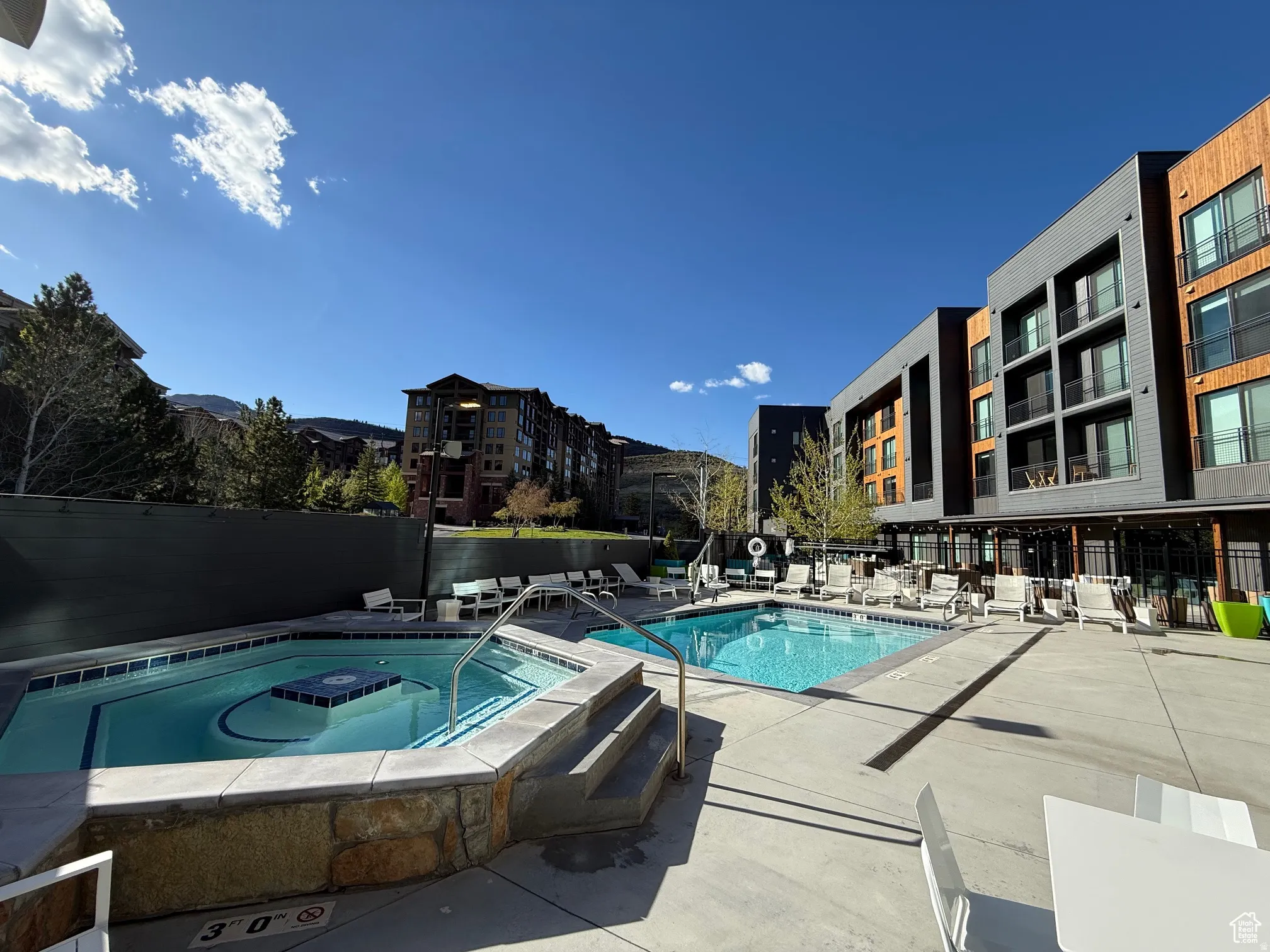 Community pool with a hot tub and a patio area