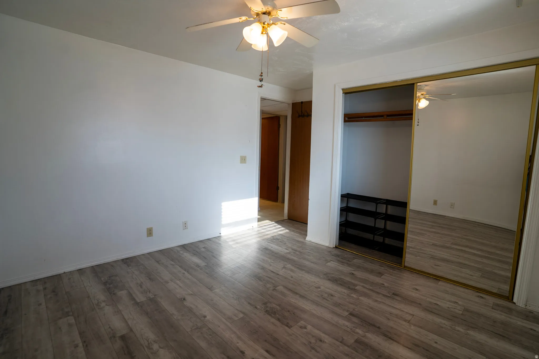 Third Bedroom (basement) featuring ceiling fan, laminate floors, and a closet
